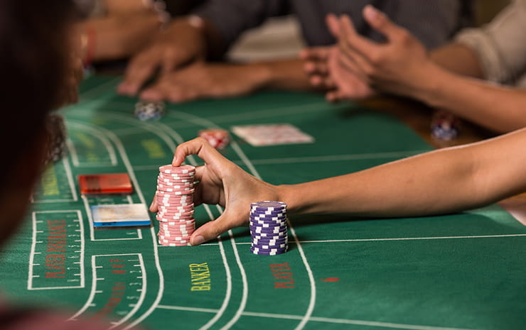 A female player pushing her chips on to the table.