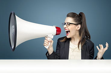 A woman holding a loudspeaker.